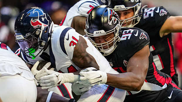 Atlanta Falcons defensive tackle Calais Campbell (93) tackles Houston Texans running back Dameon Pierce (31) during the first quarter at Mercedes-Benz Stadium.